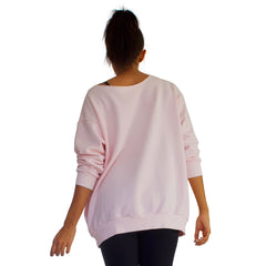 Back view of Our best selling oversized french terry top with raw edge neckline, side seam pockets shown here in Candy Pink.
