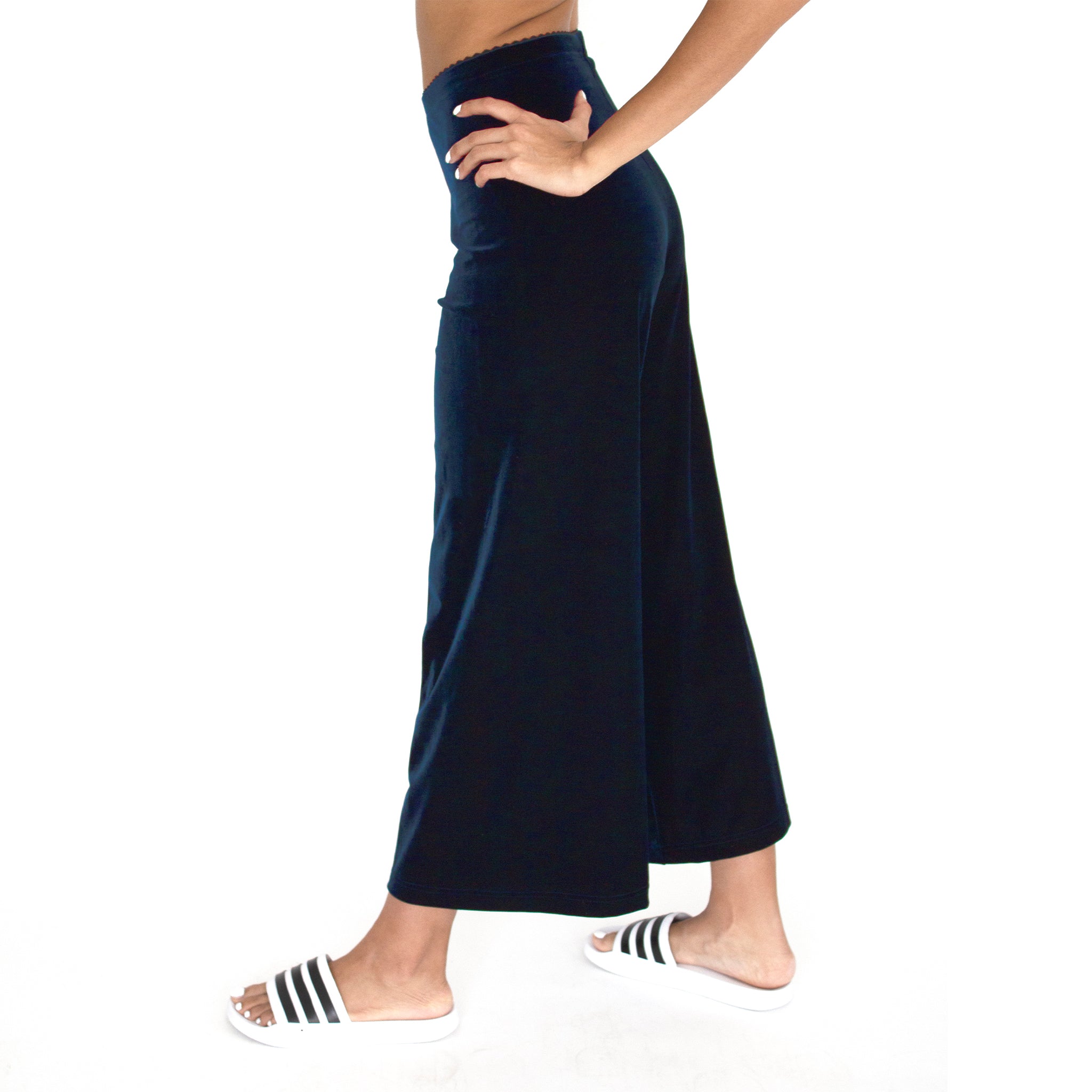 Side view of our Cropped Length Stretch Velvet Pant in Sapphire (Dark Blue) has elastic waist and 26" inseam.